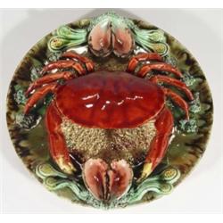 Portuguese Majolica wall plate, relief moulded with a crab and mussels, decorated in reds, greens an