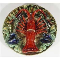 Portuguese Majolica wall plate, relief moulded with a lobster and mussels, decorated in blues, green
