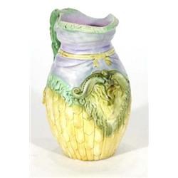 Continental Majolica jug, moulded with ram's head and ribbon decoration, decorated in yellows, green