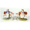 Pair of hand painted Victorian Staffordshire figures of a young boy and a girl beside cattle above a