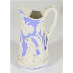19th century Dale Hill Parian jug, relief moulded with figures amongst palm trees onto a blue ground
