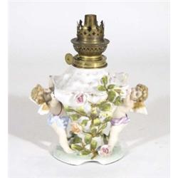 19th century German porcelain lamp base, modelled with winged cherubs and relief moulded with flower