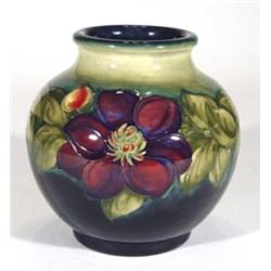 Large Moorcroft vase, hand painted and tubelined with clematis onto a blue and green ground, impress