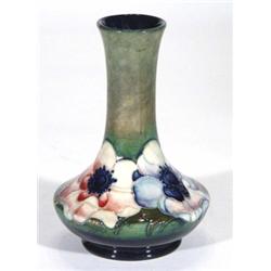 Moorcroft pottery vase, hand painted and tubelined with anemones onto a green and blue ground, paper