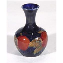 Miniature Moorcroft baluster vase, hand painted and tubelined with 'Pomegranate' pattern onto a dark