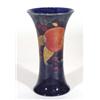 Image 1 : Moorcroft vase with flared neck, hand painted and tubelined with 'Pomegranate' pattern onto a dark b