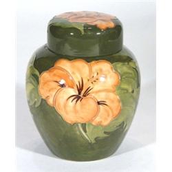 Moorcroft ginger jar and cover, hand painted and tubelined with 'Coral Hibiscus' pattern onto a gree