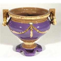 Eichwald twin handled pottery urn, relief moulded and painted with brown swags onto a purple ground,