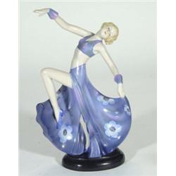 Continental porcelain Art Deco figurine in a flowing dress with outstretched arm, marks to base, 26c