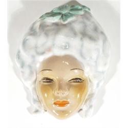 Continental pottery Art Deco wall mask of a young maiden with a bow in her hair, 22cm high