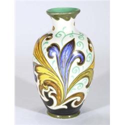 Gouda pottery vase, hand painted with yellow and blue stylised flowers onto a white and black ground