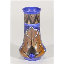 Hand painted Clews Chameleonware vase, decorated with a brown peacock feather onto a mottled blue gr