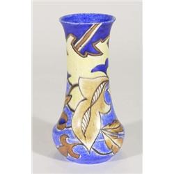 Hand painted Clews Chameleonware vase, decorated with brown flowers and leaves onto a mottled blue g