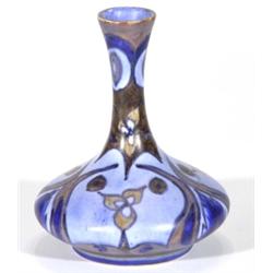 Hand painted Clews Chameleonware bottle vase, decorated with brown and blue flowers onto a mottled b