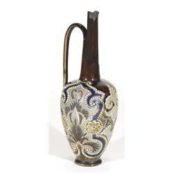 Doulton Lambeth stoneware ewer, incised and relief moulded with stylised flowers onto a brown and bl