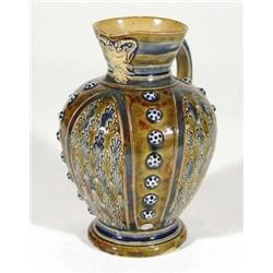 Doulton Lambeth stoneware jug, relief moulded and incised with stylised decoration and a mystical be