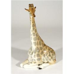 Large hand painted USSR seated giraffe, marks to base, 32cm high
