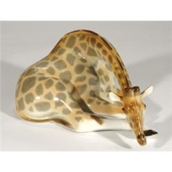 Large hand painted USSR seated giraffe, marks to base, 26cm in length