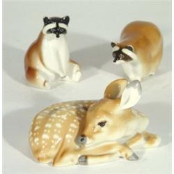 Hand painted Russian sleeping faun and two USSR racoons, marks to bases, largest 13cm high