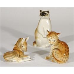 Hand painted USSR racoon, zebra and a leopard, marks to bases, largest 16cm high