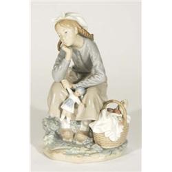 Hand painted Lladro seated girl clutching a doll beside a basket of fruit, marks to base, 24cm high
