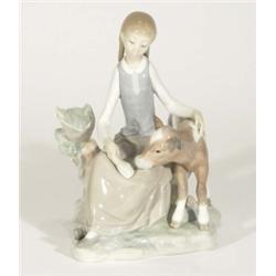 Hand painted Lladro figurine of a young girl feeding a calf, marks to base, 22cm high