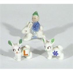 Hand painted Wade leprechaun on rabbit's back and two Minikins, largest 4cm high