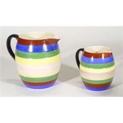 Two graduated George Jones pottery jugs, hand painted with coloured bands, marks to bases, largest 1