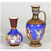 Victorian pottery single handled vase and a matching vase, hand coloured and transfer printed with '