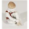 Hand painted Hungarian porcelain boy tying his shoes, marks to base, 10cm high
