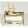 Hand painted porcelain mother pig rocking a piglet in a crib, 10cm high