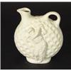 White glazed ceramic golf ball design ewer, relief moulded with a golfer, 22cm high