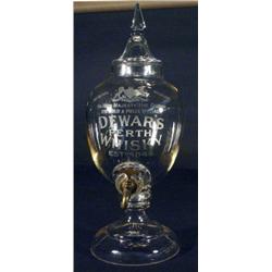 Cut glass Dewers Whiskey decanter with brass tap engraved with an armorial crest and 'Dewers Whiskey