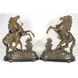 Pair of Victorian French spelter groups of young men on prancing horses on ebonised wooden bases, 44
