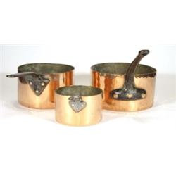 Three 19th century iron handled copper saucepans, largest 27cm diameter