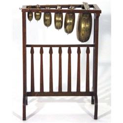 Oak framed Arts and Crafts style six piece brass Gamalan musical percussion instument, 80cm high