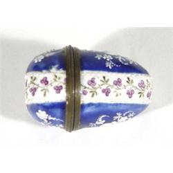 Chelsea enamel egg shaped nutmeg grater, hand enamelled with sprigs of flowers onto a blue and white