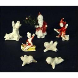 Group of bisque Christmas decorations including Santa Clause, elves and snowbabies