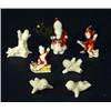 Group of bisque Christmas decorations including Santa Clause, elves and snowbabies
