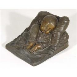 Continental bronzed metal figure of a sleeping child entitled 'Le Sommeil', 16cm in length