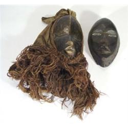 Two carved wooden African Dam masks, one with headdress