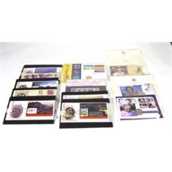 Selection of first edition covers and coins in leather binders