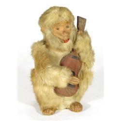 Clockwork animated fur covered monkey guitar player, 28cm high