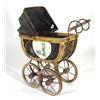 Edwardian cane framed doll's pram on an iron base