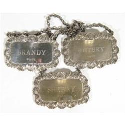 Rectangular silver sherry label, brandy label and a whiskey label