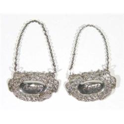 Pair of silver port and brandy labels, embossed with stylised swags, '925' marks to front, 5cm in le