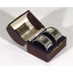 Cased pair of floral embossed silver napkin rings, Birmingham, 1911