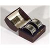 Cased pair of floral embossed silver napkin rings, Birmingham, 1911