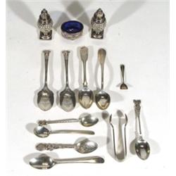 Group of silver items including pair of pepperettes, salt with blue glass liner, teaspoon, sugar ton