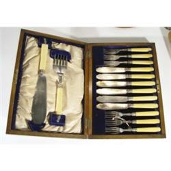 Brass inlaid oak cased set of six fish knives and forks and servers